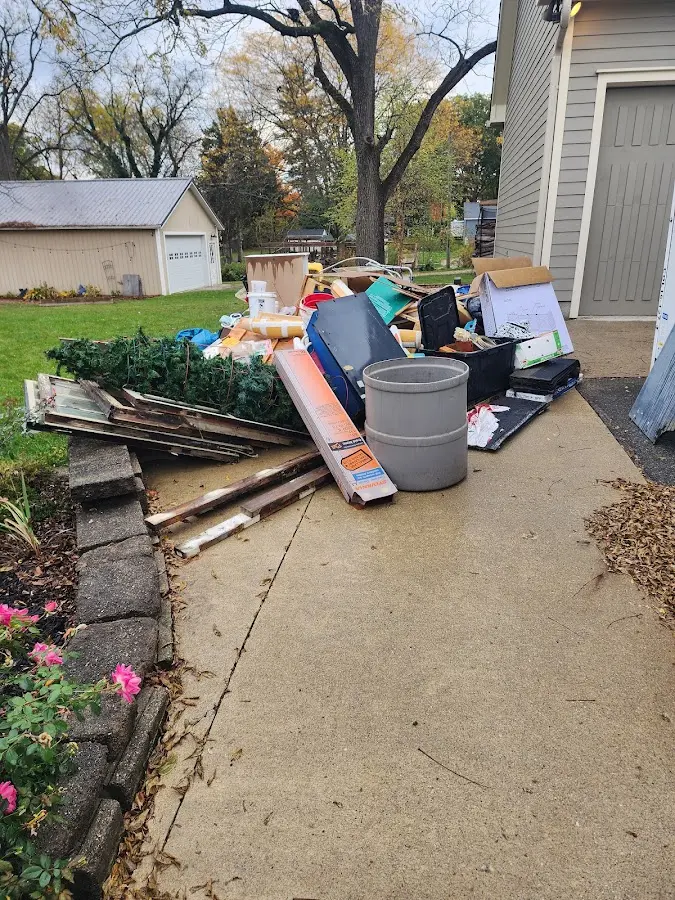 Dumpster being loaded with debris for Residential Dumpster Rental in Coralville